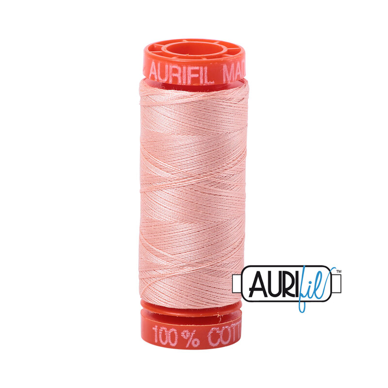 Fleshy Pink colored thread on an orange spool, isolated on a white background