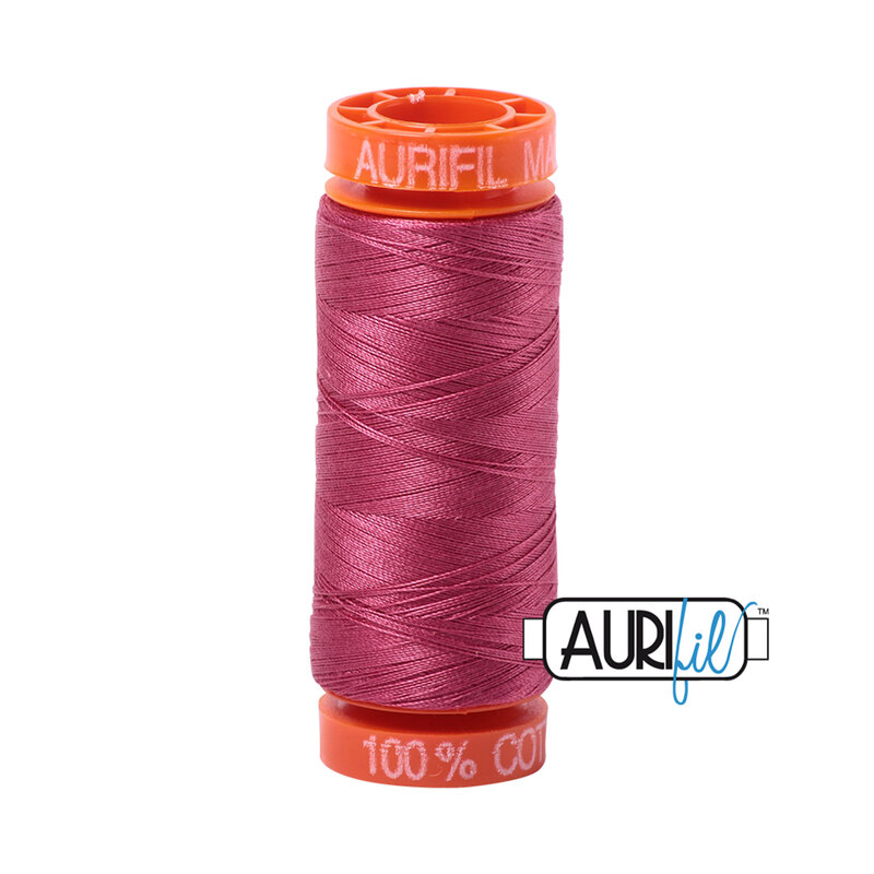 Medium Carmine Red thread on an orange spool, isolated on a white background