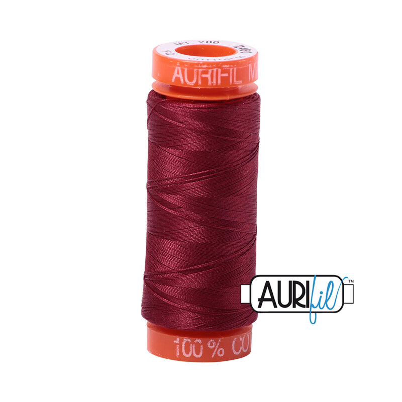 Dark Carmine Red thread on an orange spool, isolated on a white background