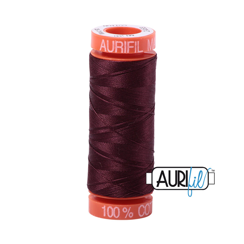 Dark Wine thread on an orange spool, isolated on a white background