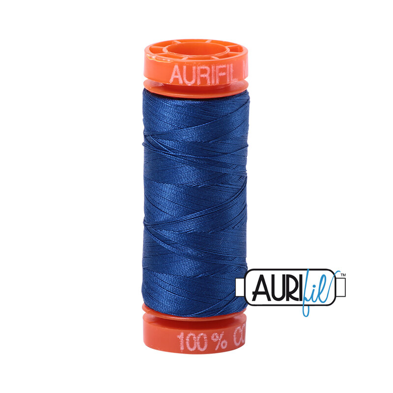 Dark Cobalt thread on an orange spool, isolated on a white background