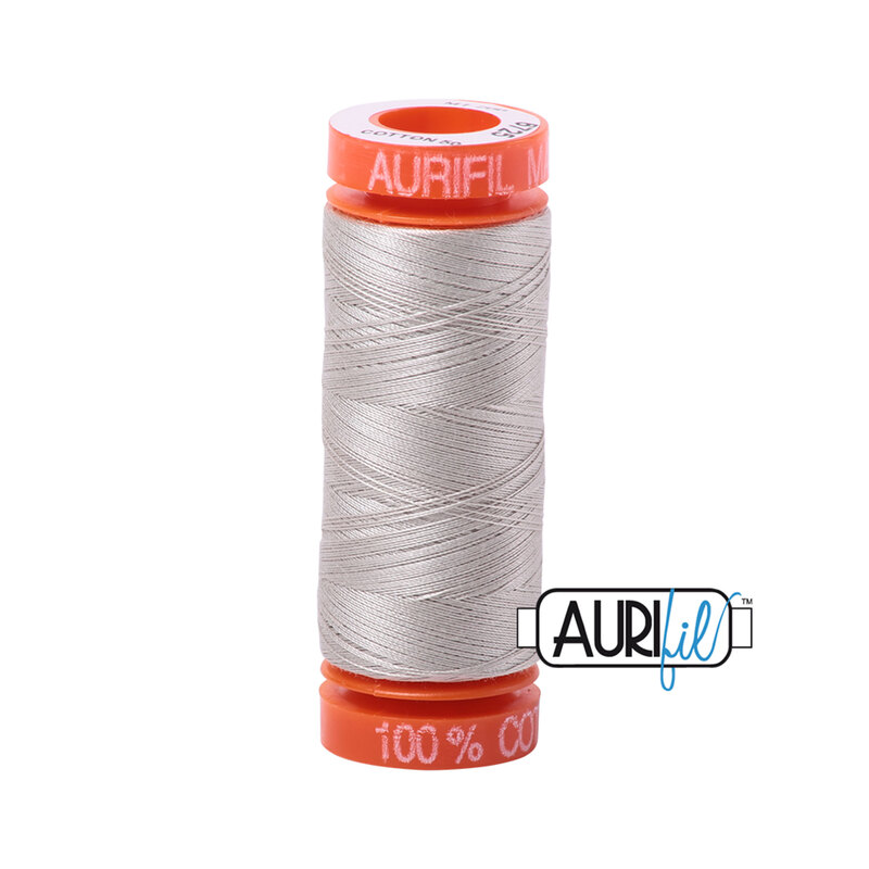 Moondust thread on an orange spool, isolated on a white background