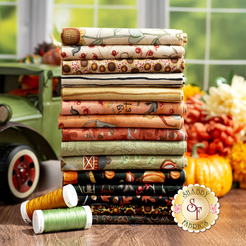 A photo of all bittersweet farm fabrics in warm shades of cream, tan, orange, green, and black