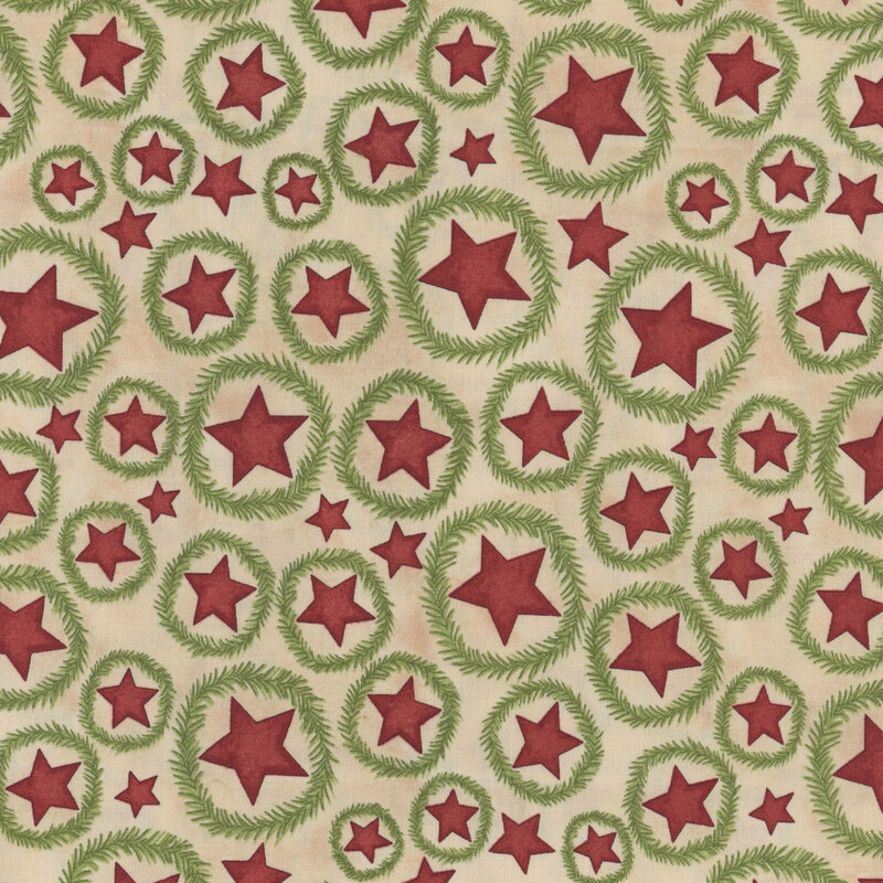 cream fabric featuring scattered red stars with fir wreaths surrounding them