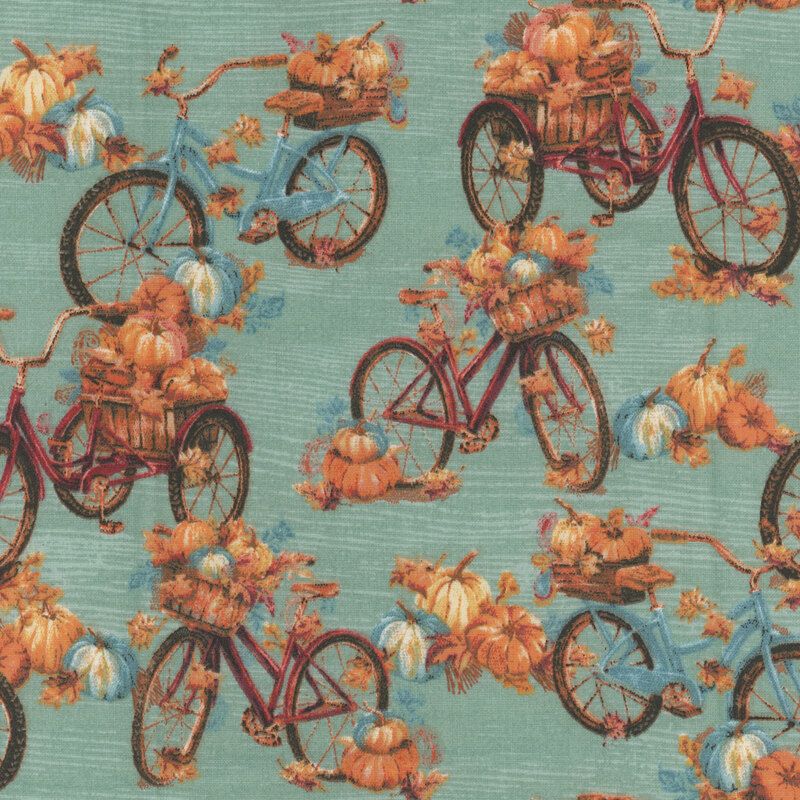 Teal fabric with red an blue bikes with piles of pumpkins in the baskets.