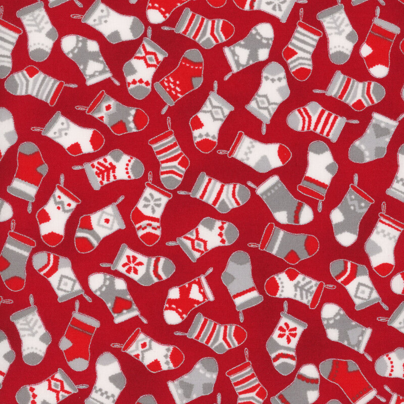 red fabric tossed with christmas stockings