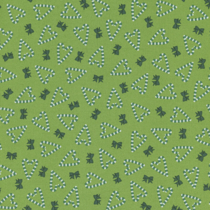 green fabric featuring heart shaped candy canes and bows