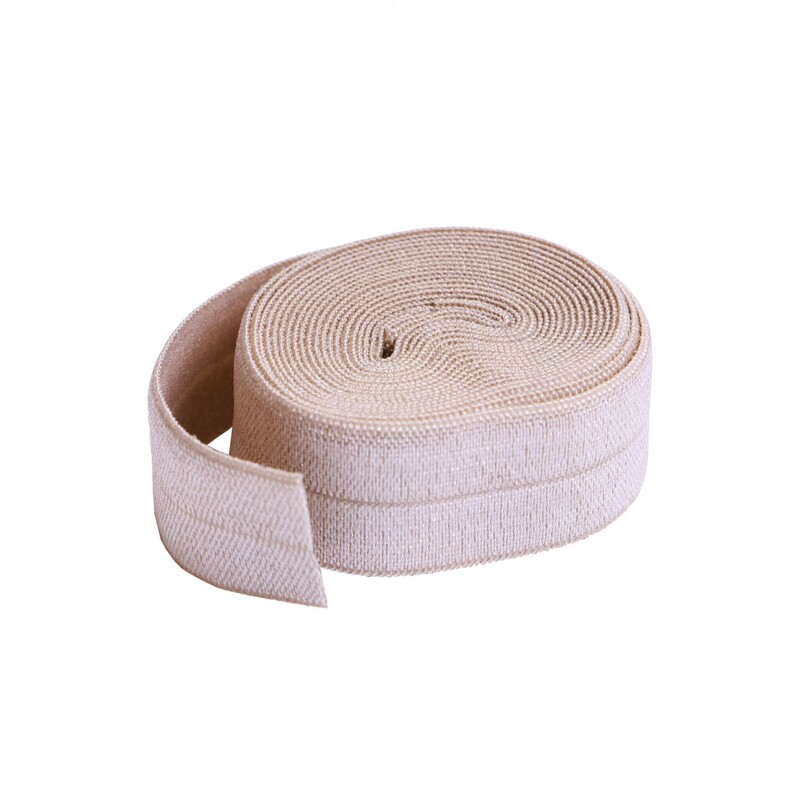 A circular roll of beige elastic, 3/4