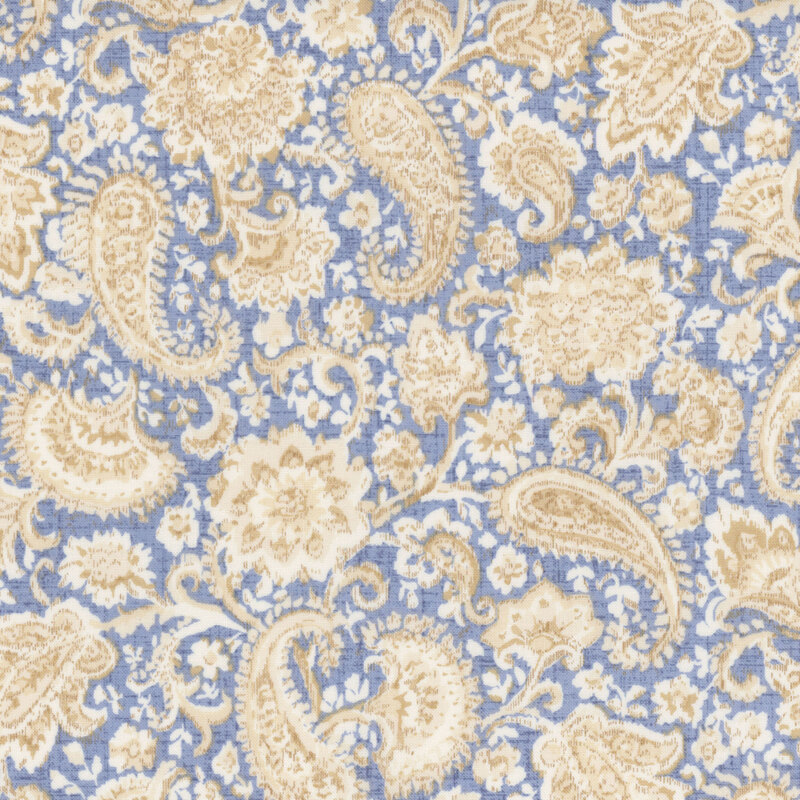 light denim blue textured fabric featuring scattered textured florals and paisley motifs in shades of cream