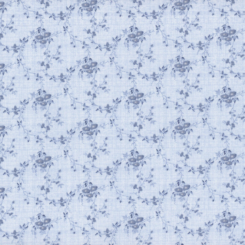 light denim blue textured fabric featuring scattered tonal textured vines and small flower bunches