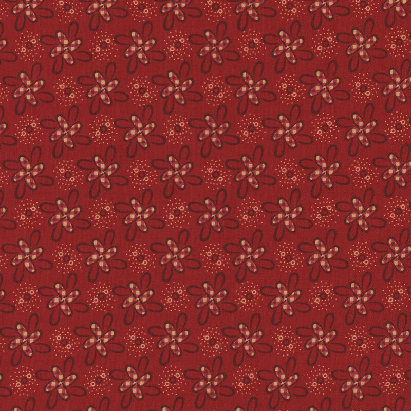 Red fabric with pinwheel-like floral motifs with red gingham details.