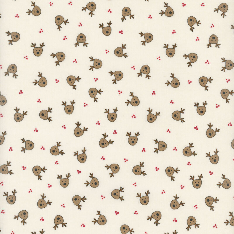 Cream fabric featuring small brown illustrated reindeer heads evenly spaced and tossed all over.