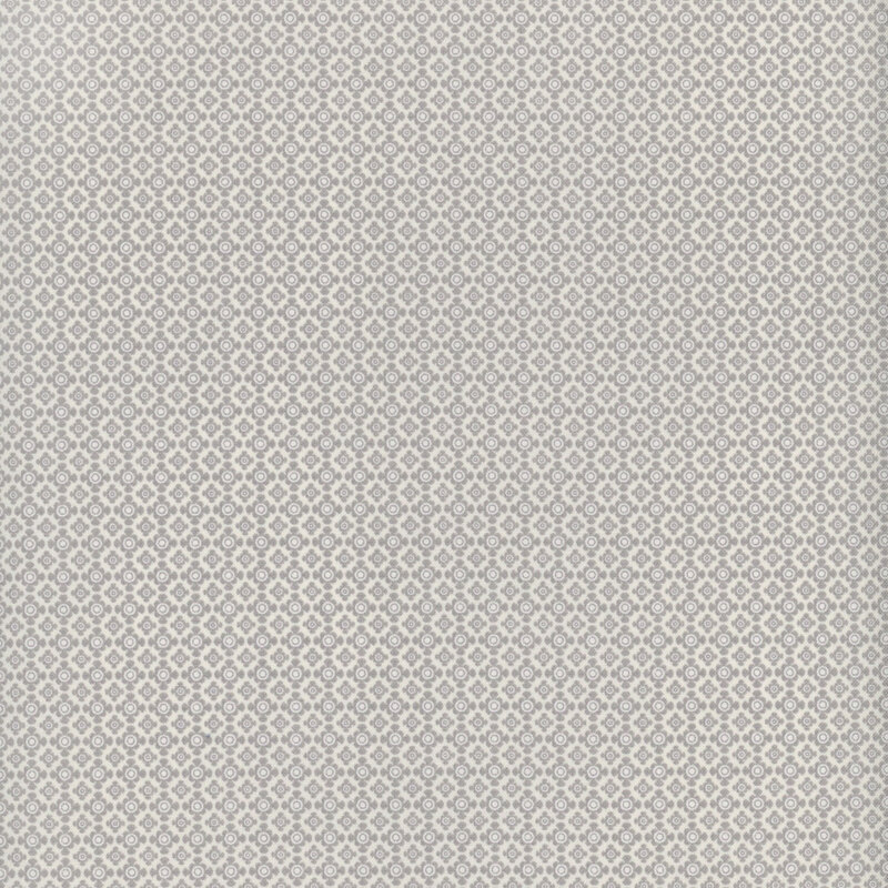 Tonal gray fabric with a visually interesting geometric pattern in a lattice-like pattern with rounded shapes against a pale background.