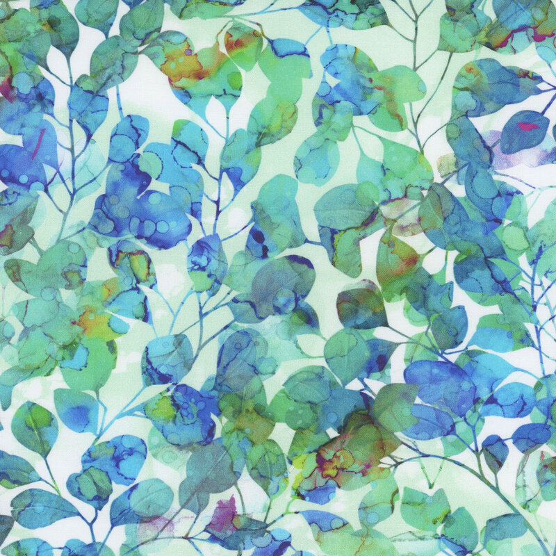 White fabric with aqua, teal, green, and blue silhouettes of leafy branches packed in the foreground