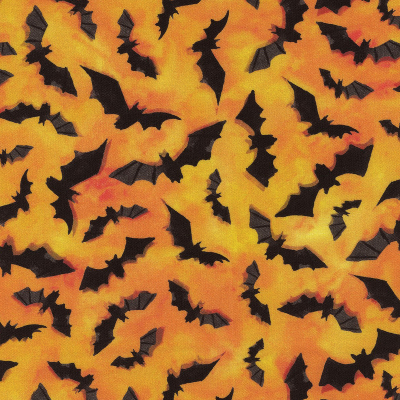 Mottled orange fabric with little black bats all over.