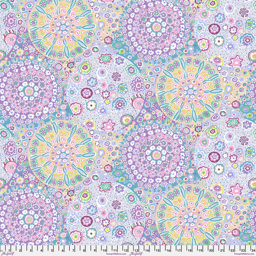 Fabric featuring vibrant multicolor kaleidoscopic abstract designs, shaped around circles.