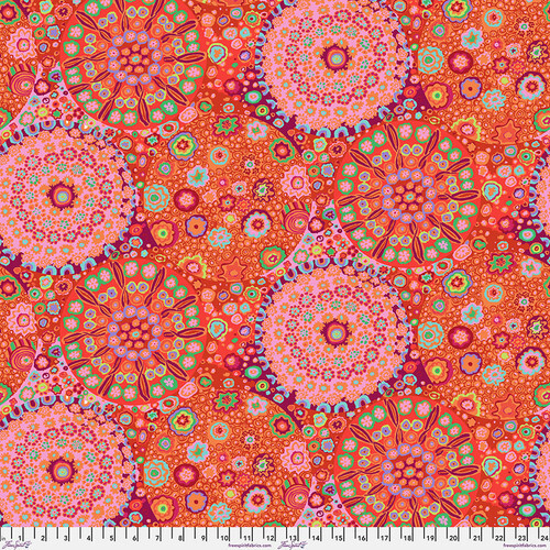 Fabric featuring vibrant multicolor kaleidoscopic abstract designs, gathered into large medallions.