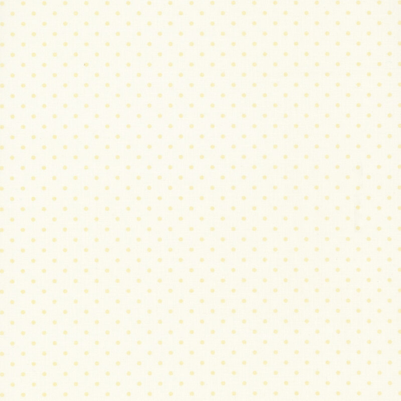 Cream fabric with tonal pinprick polka dots.