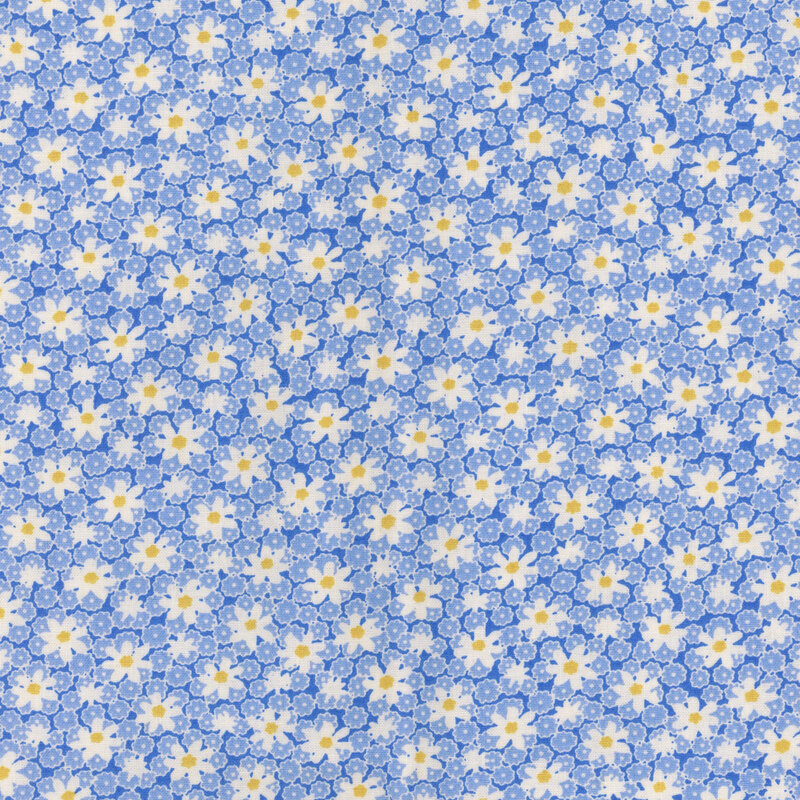 Blue fabric with floral pattern of small blue flowers and white daisies.