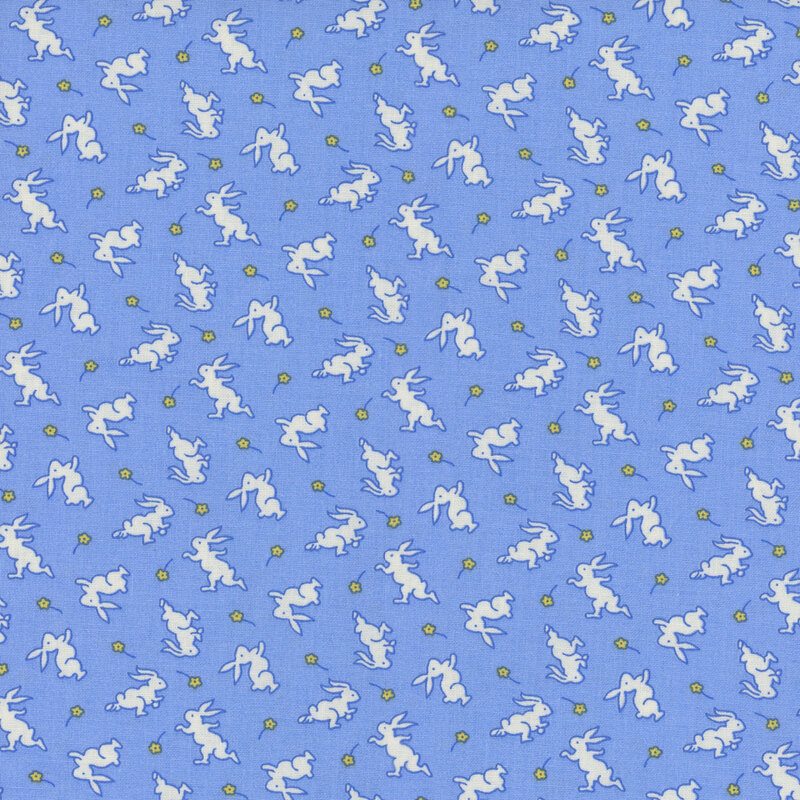 Blue fabric with white bunnies and small yellow daisies.