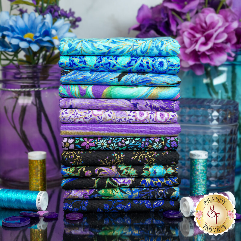 A stack of fabrics in the Luminous FQ set with vases and thread and flowers and buttons.