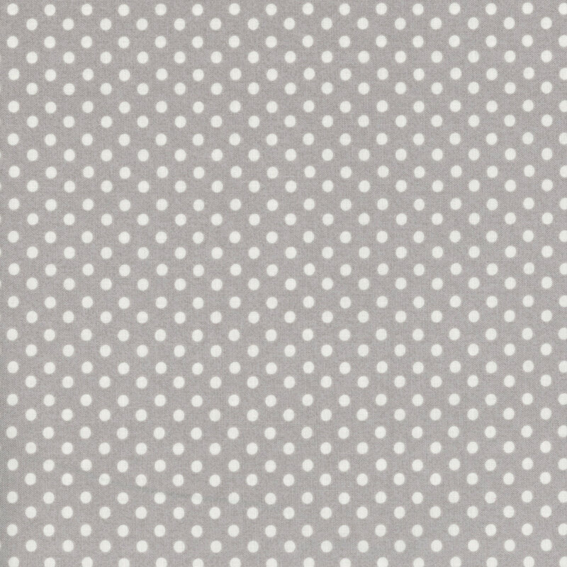 White polka dots on gray fabric.