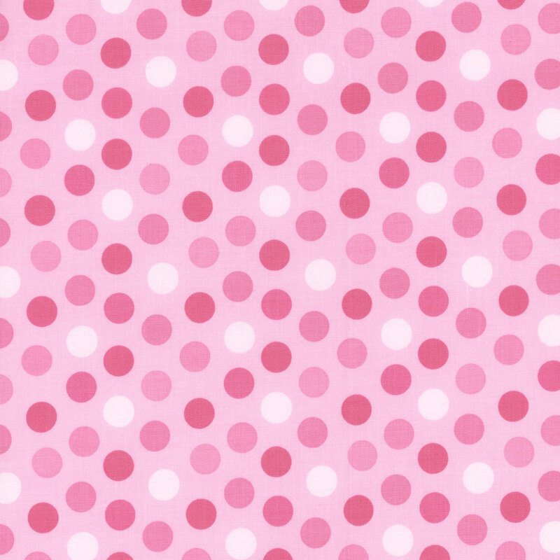 soft pink fabric featuring medium polka dots in white and darker shades of pink