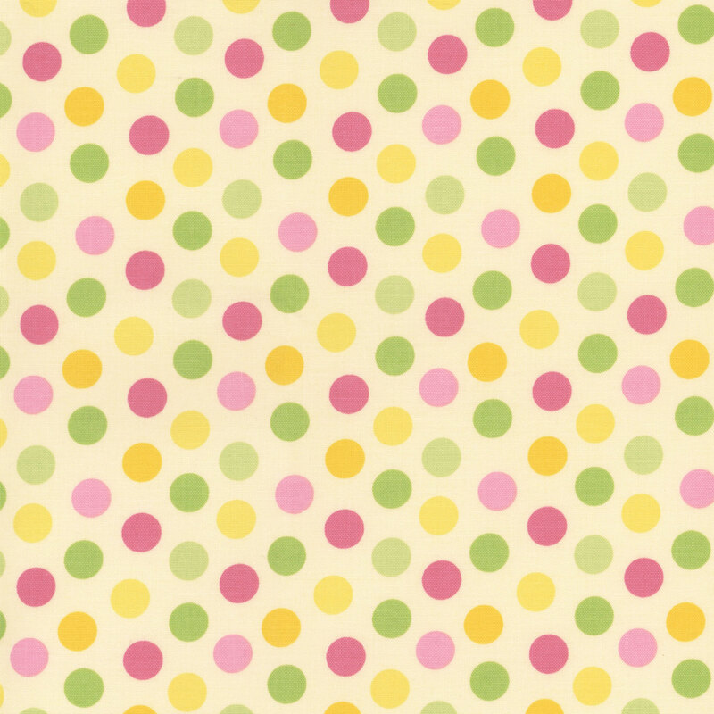 soft yellow fabric featuring medium polka dots in 2 different shades of pink, green, and yellow