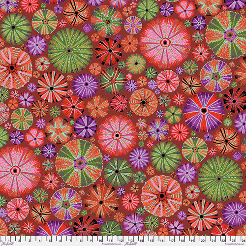 Rusty red print with round sea urchins of varying sizes in orange, red, green, and purple.