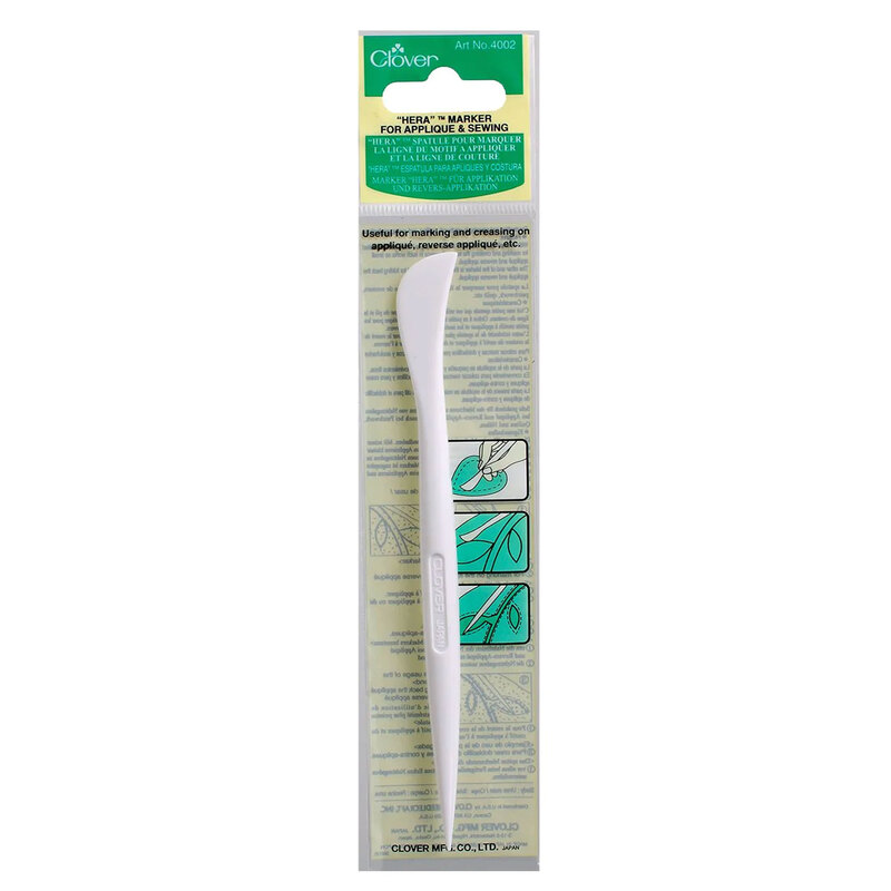 White fabric marking tool in packaging with usage instructions and brand logo.