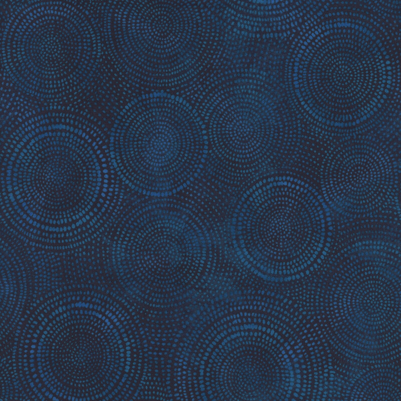 Photo of dark blue mottled fabric with lighter tonal rings made up of tiny dashes