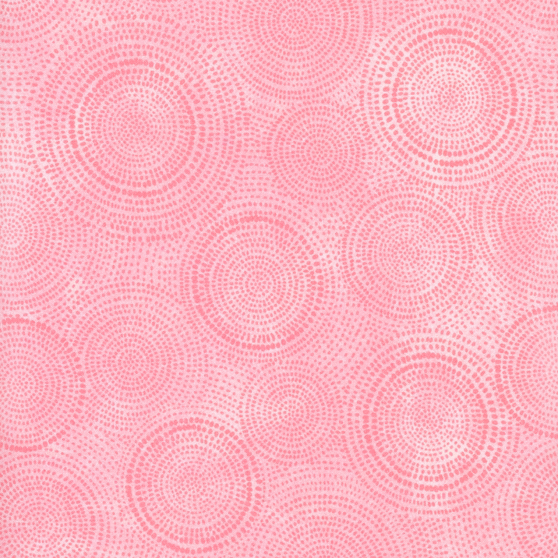 Photo of light pink mottled fabric with darker tonal rings made up of tiny dashes