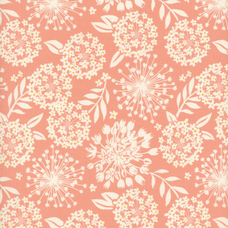 A pink colored fabric with cream colored silhouettes of flowers and leaves.