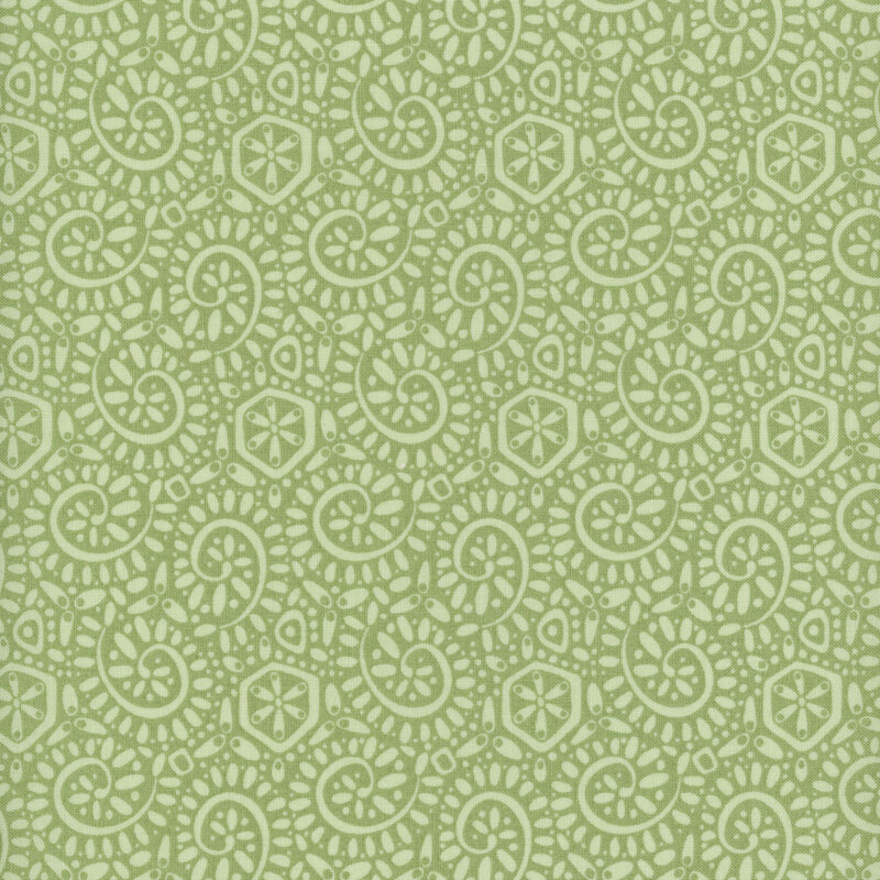 Green fabric with a packed pattern of light sage ammonite swirls and dots.