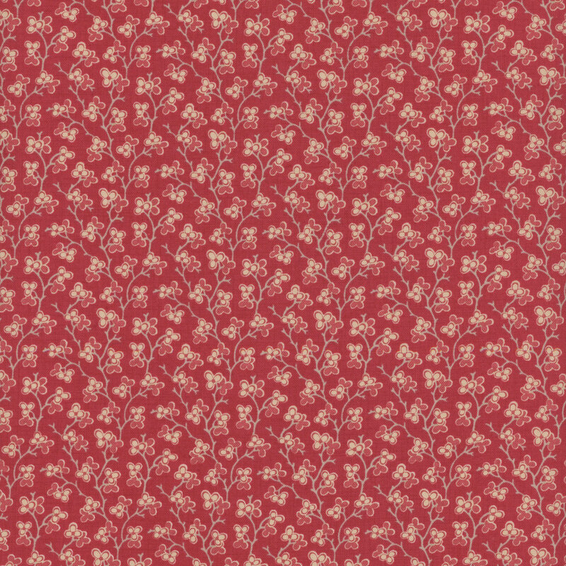 red fabric featuring a dark pink and cream floral design