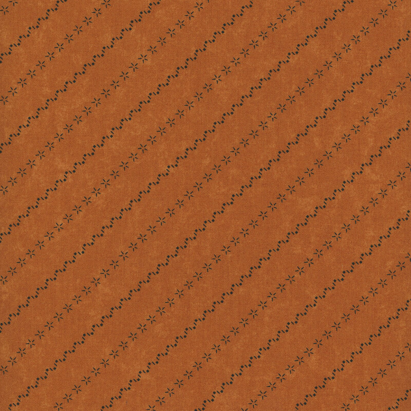 Rusty orange mottled fabric with alternating diagonal stripes made of stars and zig-zag patterns.