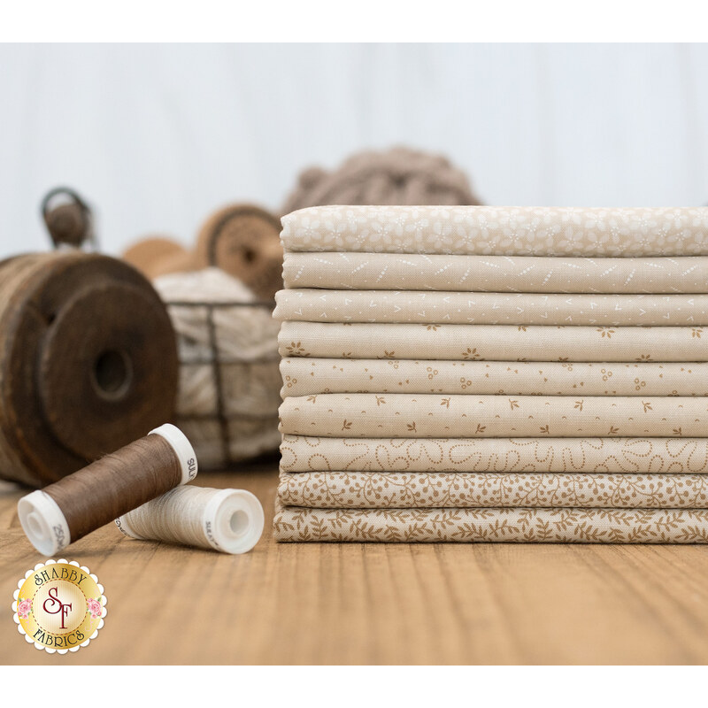 A KT Favorites Backgrounds 9 FQ Set surrounded by threads and spools.