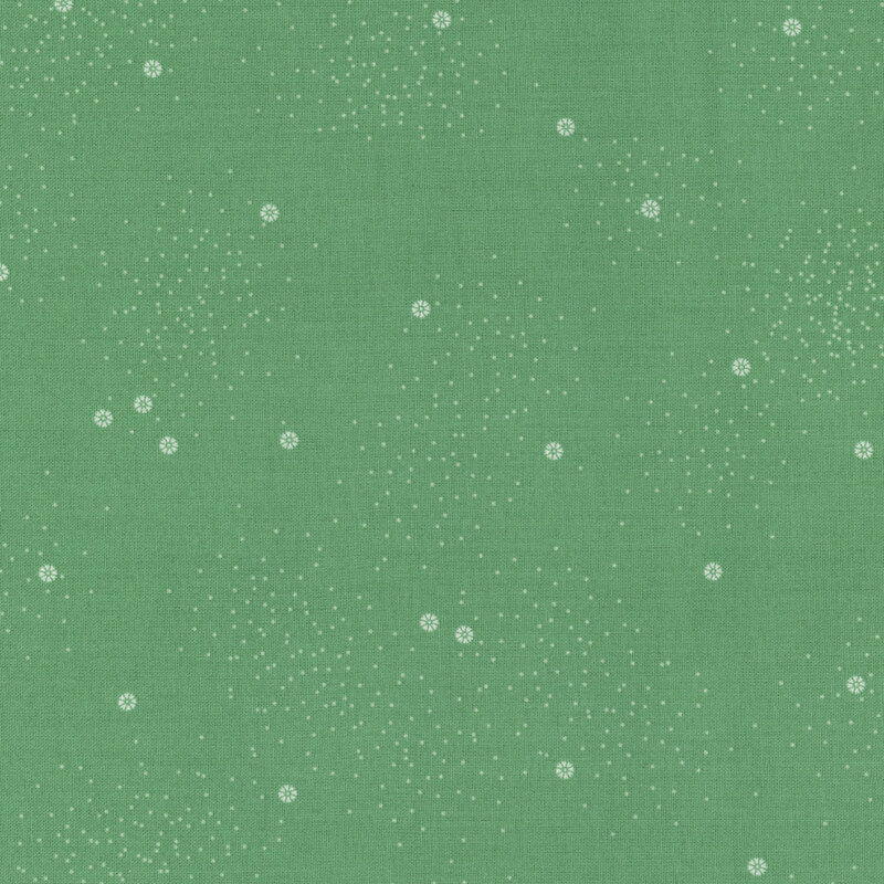 A solid green fabric background with a scattered pattern of small white dots and flowers.