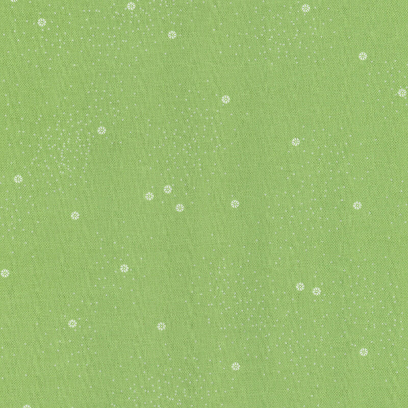 Light green fabric with a scattered pattern of small white dots and flowers.