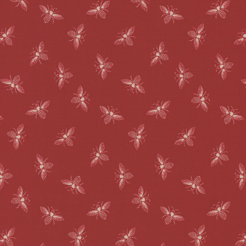 Apple red fabric with off-white ditsy bees all over.