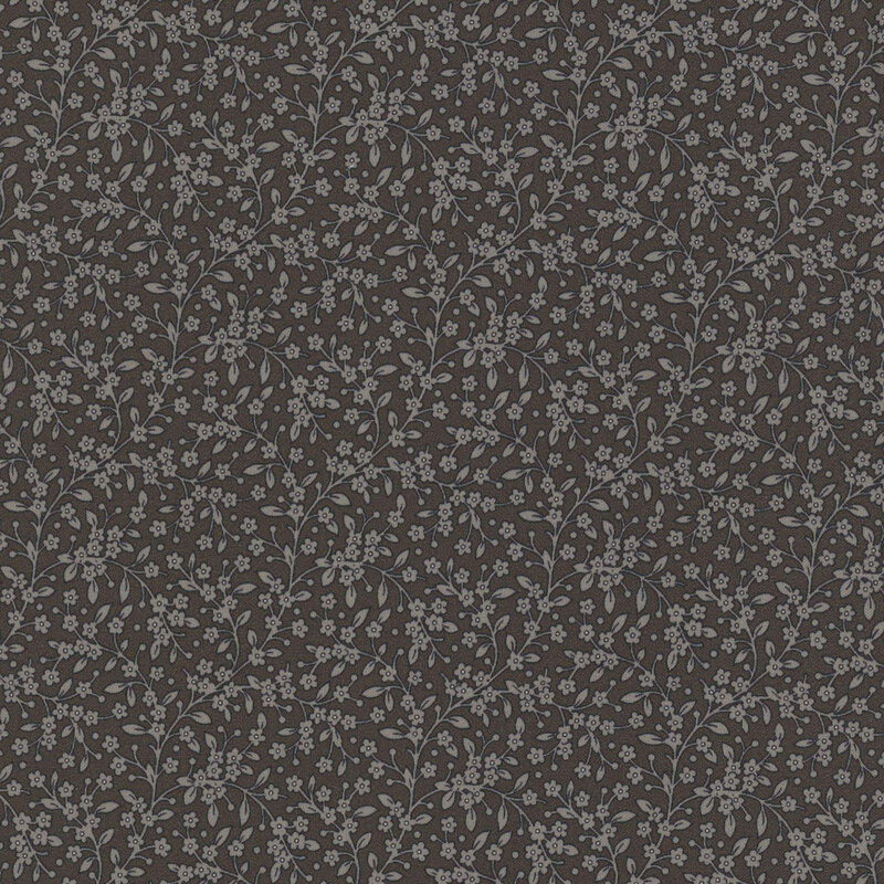 Section of fabric with gray leaves and vines all over a dark gray background