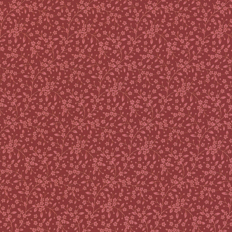 Tonal raspberry-red fabric with light red leaves and vines all over.