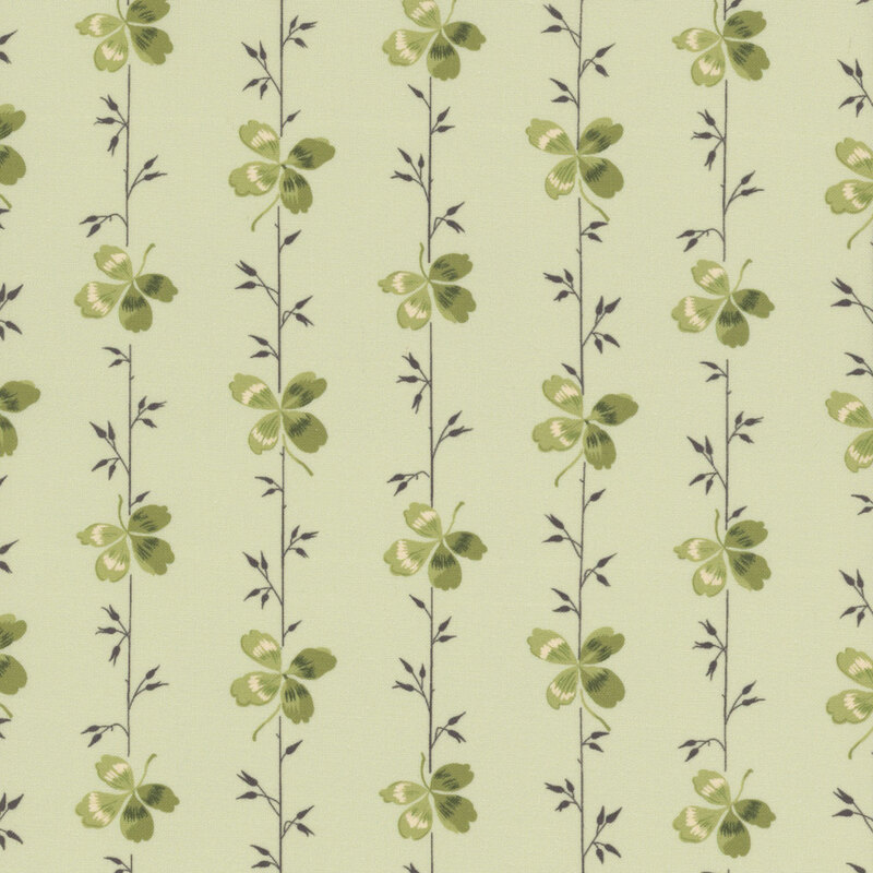 A light green fabric featuring stripes with small sprigs and clovers.