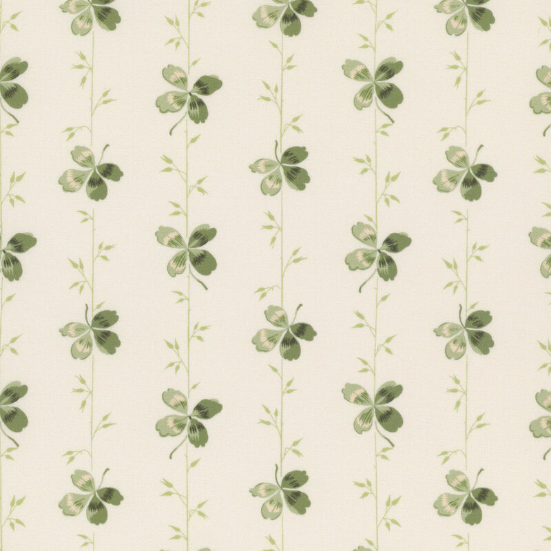 A light cream fabric with green stripes made of vines and clovers.