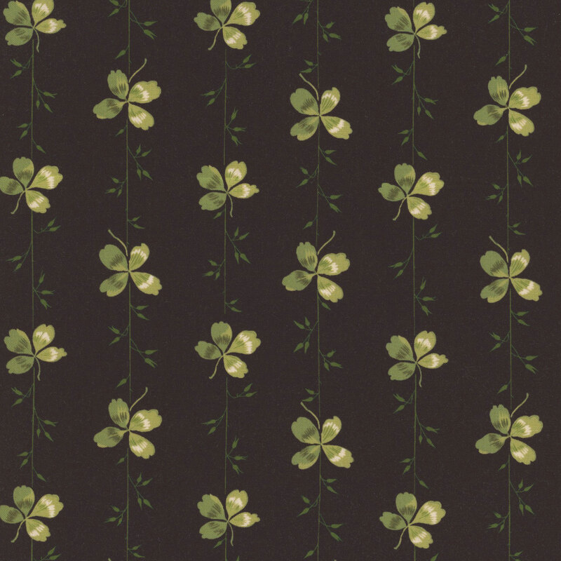 A solid black fabric with green stripes made of vines and clovers.