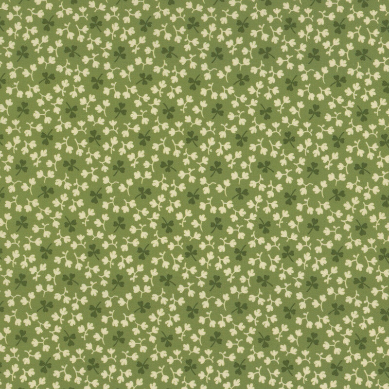 Forest green fabric with tossed dark green shamrocks and little off-white leaves all over.