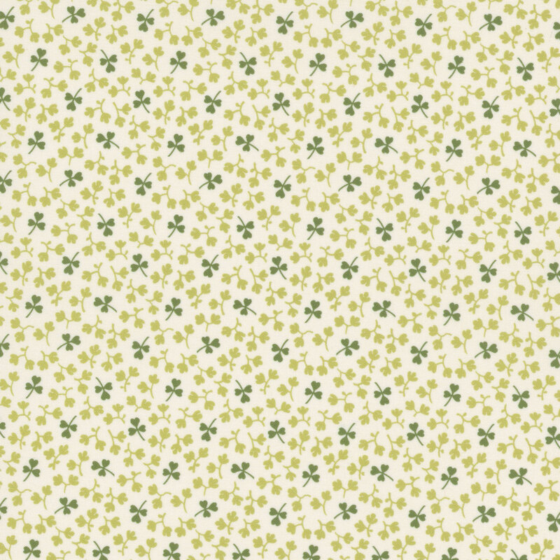 Light cream fabric with small dark green shamrocks and light green leaves all over.