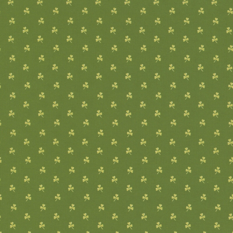 Dark green fabric with small light green clovers spaced evenly all over.