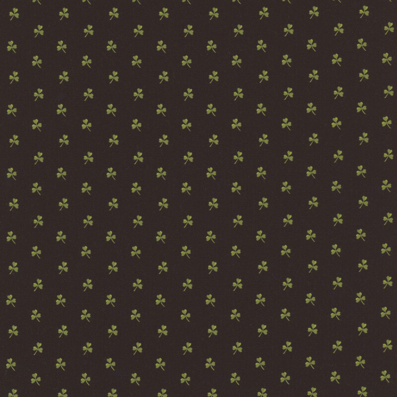 Black fabric with small green evenly-spaced shamrocks all over.