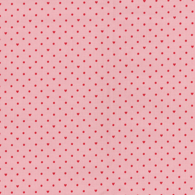 Light pink fabric with small red polka dots and hearts throughout